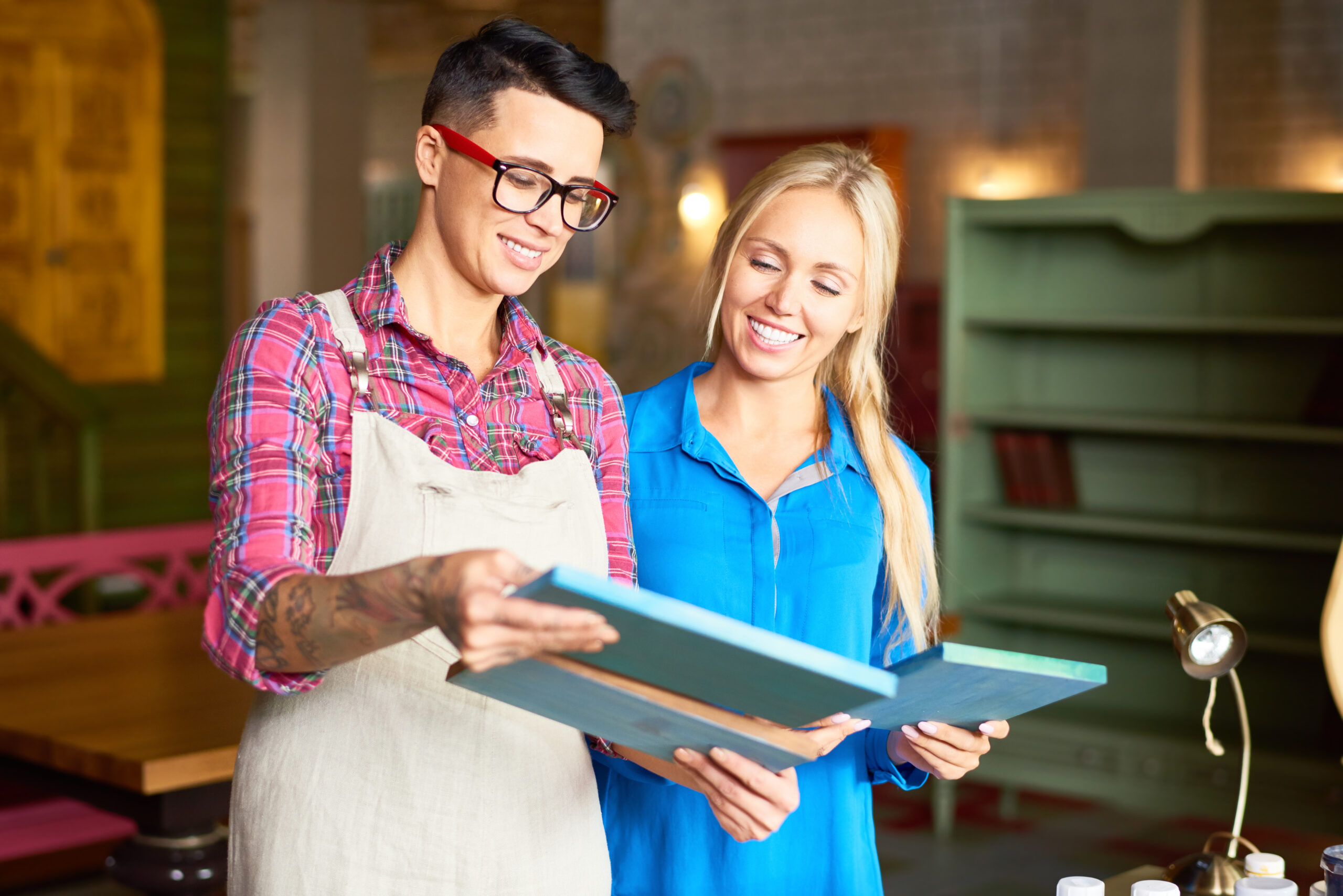 Two Women Choosing Pictures for Interior Decor